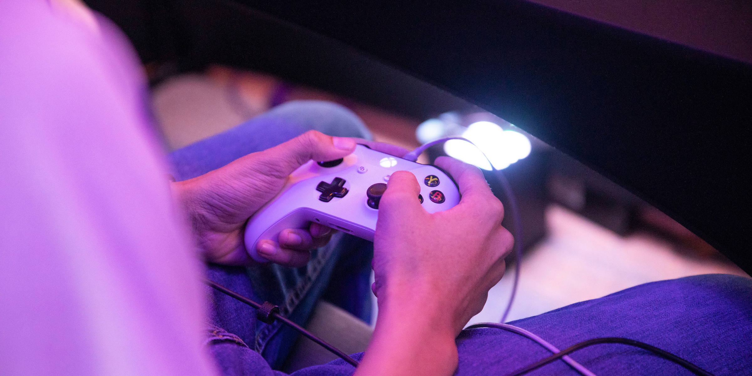 A student grips an Xbox One controller while playing during tournament.