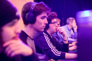 A group  of 5 students play at an esports tournament.