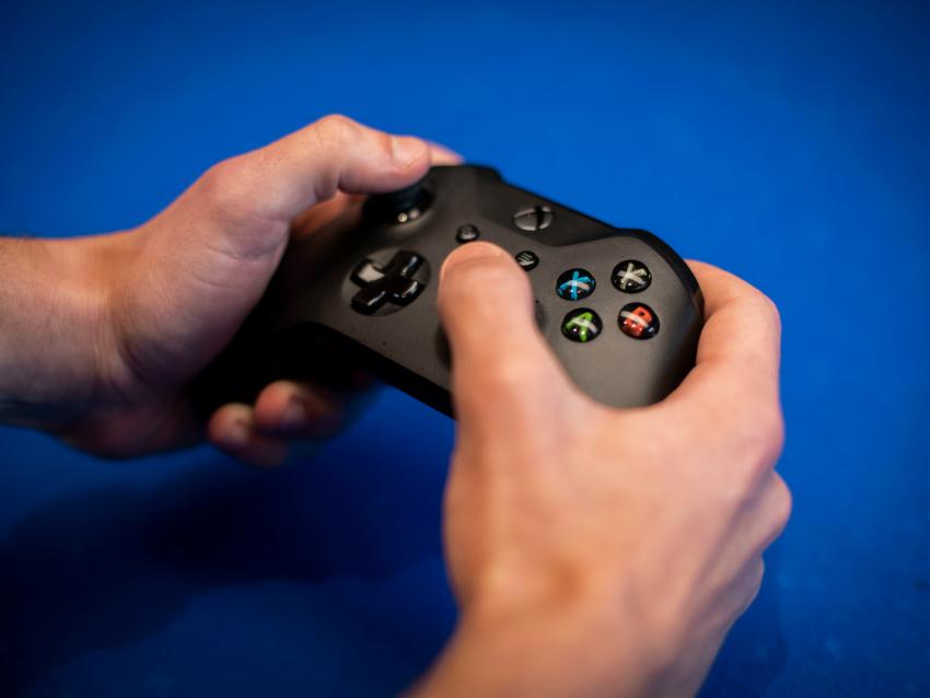 A student holding an Xbox Controller