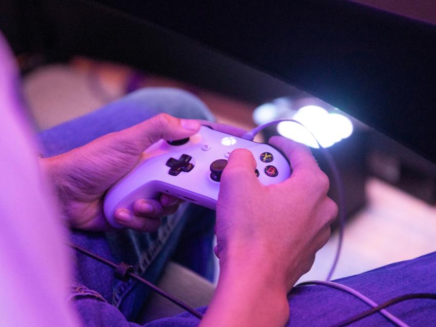 A student grips an Xbox One controller while playing during tournament.